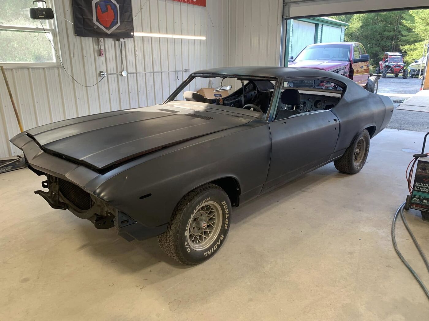 Chevelle shell in primer inside the shop