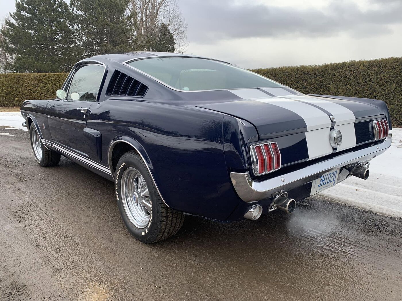 Dark blue fastback Mustang with white stripes